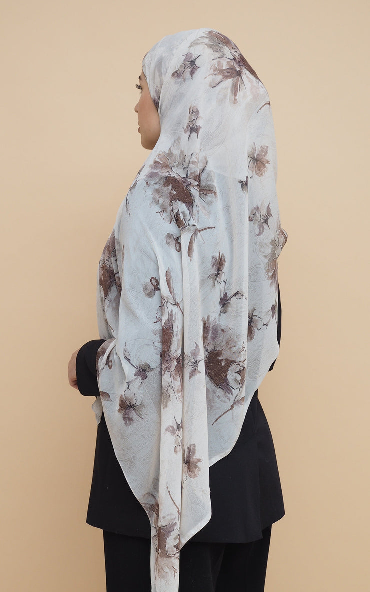 Woman wearing printed chiffon hijab with brown flowers